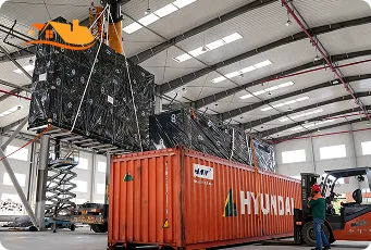 Machine Loading Lyngou Prefab Home Parts Into Container