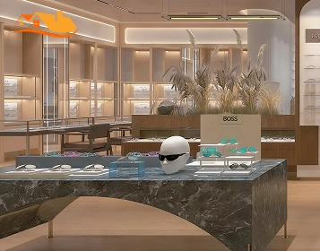 Luxury eyewear showroom with stone display table, branded display area, and illuminated wall cabinets