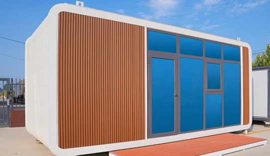 Prefab Capsule House With Curved Frame And Vertical Wood Cladding